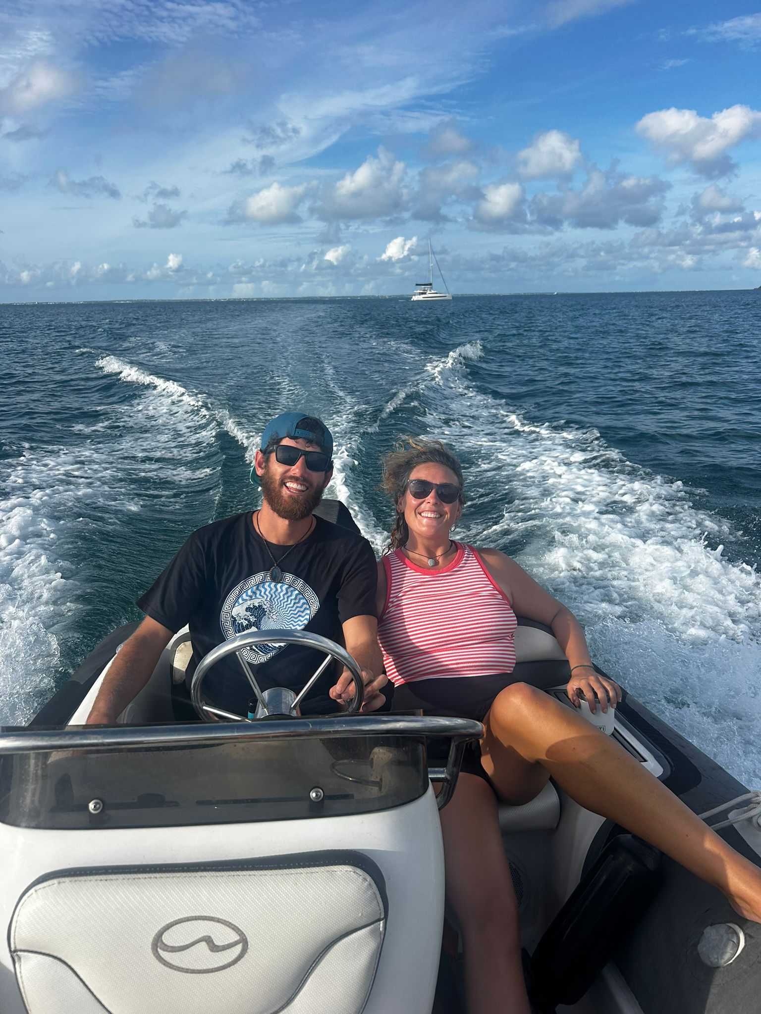 Captain Jan-Hendrik and First Mate Katie on the RIB with a catamaran behind